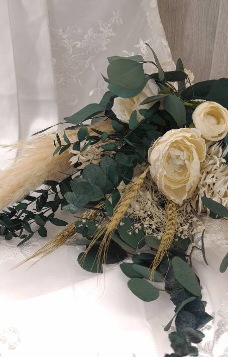 Bridal bouquet with preserved foliage and dried flowers is perfect for a minimalistic wedding theme. A beautiful mix of preserved eucalyptus, dried pampas grass, preserved gypsophila, dried wheat and artificial peonies.