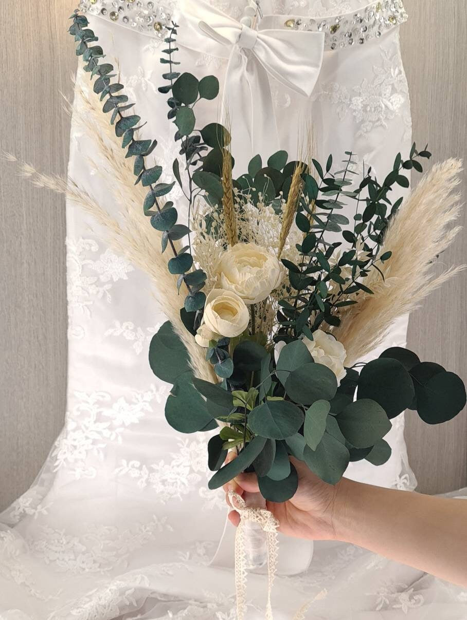 Bridal bouquet with preserved foliage and dried flowers is perfect for a minimalistic wedding theme. A beautiful mix of preserved eucalyptus, dried pampas grass, preserved gypsophila, dried wheat and artificial peonies.