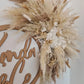 Decorative wall hanging wreath with dried pampas grass and floral elements for mirrors and signs 