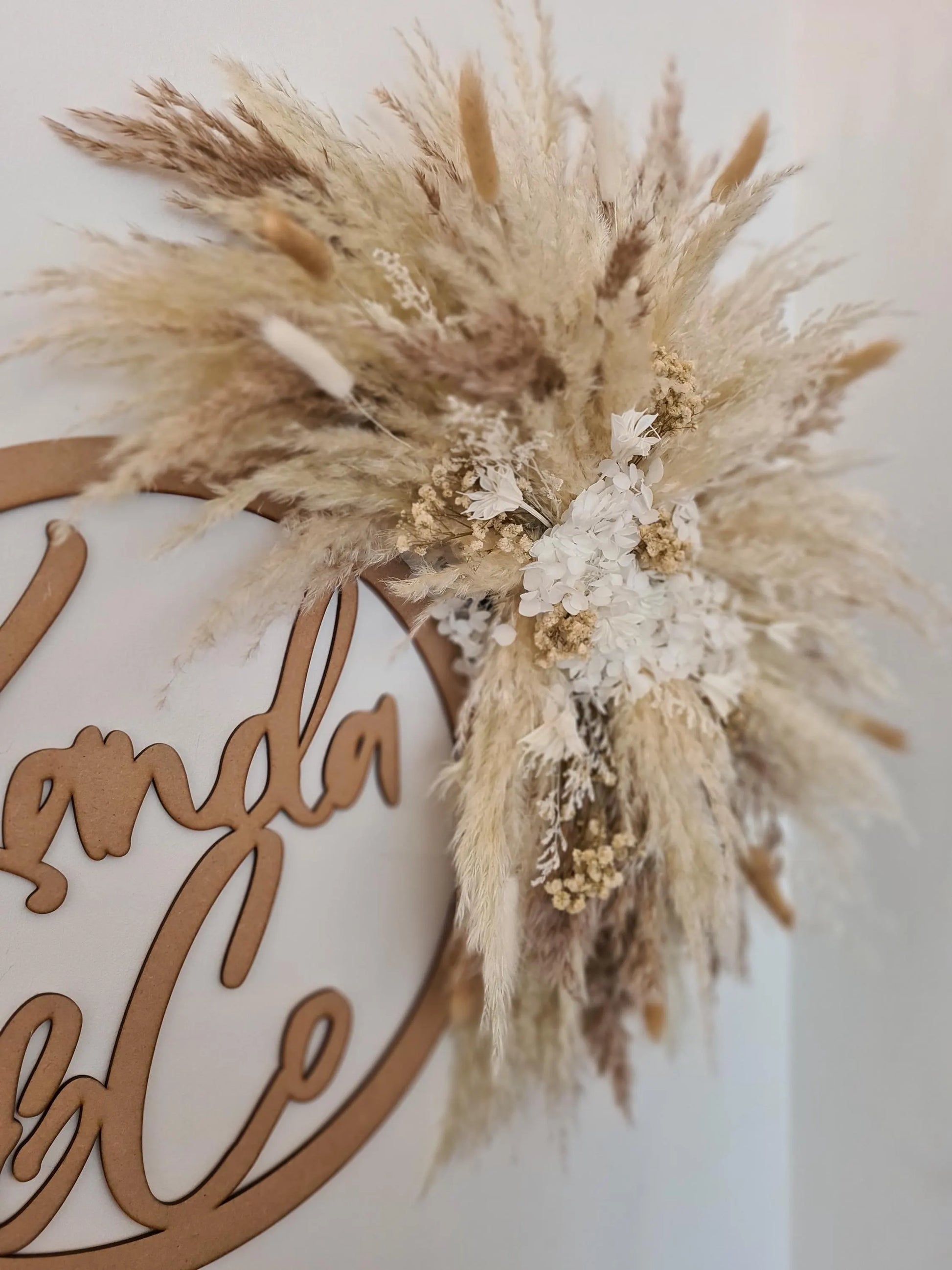 Decorative wall hanging wreath with dried pampas grass and floral elements for mirrors and signs 